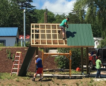 Photo of construction of a mailbox/bus stop shelter at Lamprey River Cooperative.